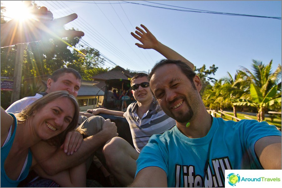 We ride with the breeze in the back of a pickup truck, like real backpackers