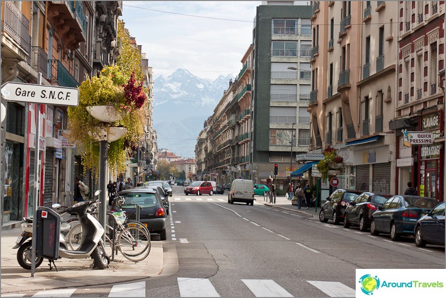 Signpost to Grenoble train station and French Alps