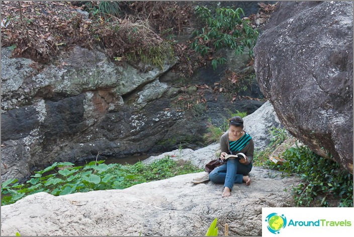 Locals have a rest near the waterfall