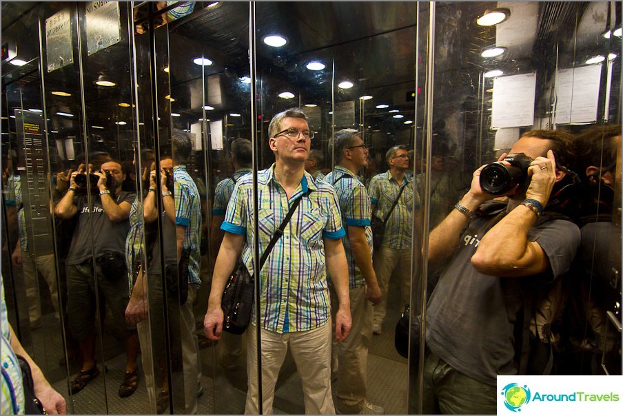 The elevator is mirrored, people multiply and multiply