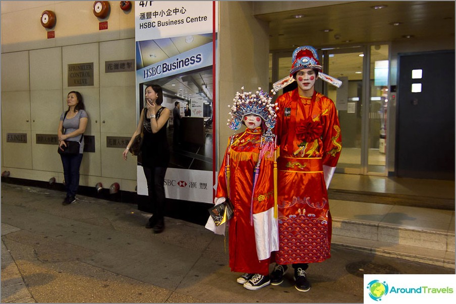 Costumed Chinese beckoning somewhere