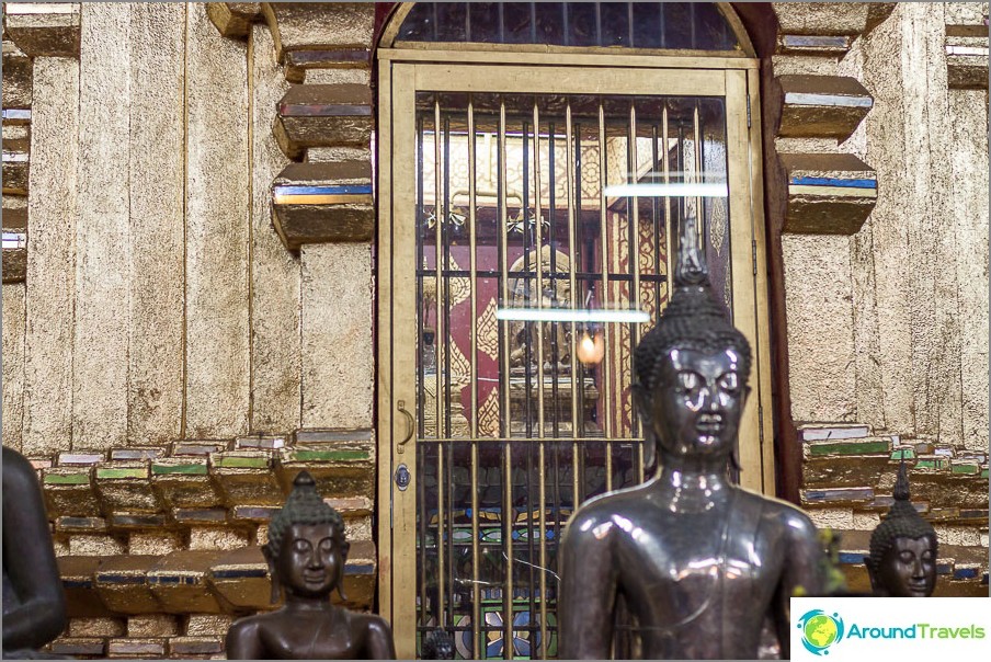 Statue of Buddha hidden behind bars